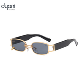 The Rebel sunglasses with gold metal frame, chain-link bridge, dark-tinted rectangular lenses, and wide black arms.