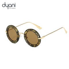 Dyani Solaris retro sunglasses with bold round frames and brown lenses, featuring sleek metal arms.