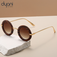 Solaris sunglasses with round frames, thick contrast rim, and sleek metal arms, showcased on a minimalist stone surface.