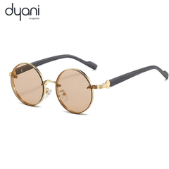 The Orbis cool festival round sunglasses with gold frame and brown lenses featuring intricate temple detailing by Dyani Sunglasses