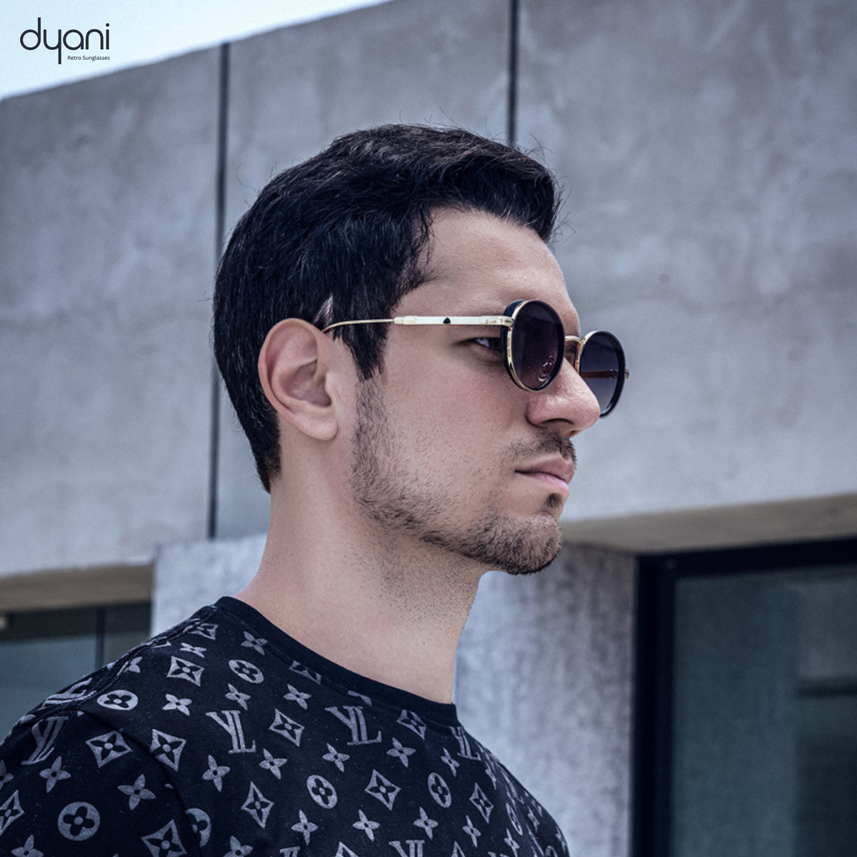Man wearing The Luna steampunk round sunglasses with vintage charm and modern style against an urban background.