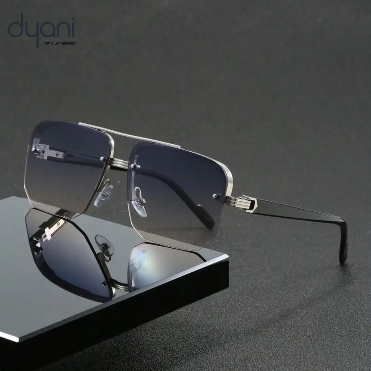 The Apex Sunglasses by Dyani with sleek boxy design and polycarbonate frame, reflecting modern style and boldness on a dark surface.