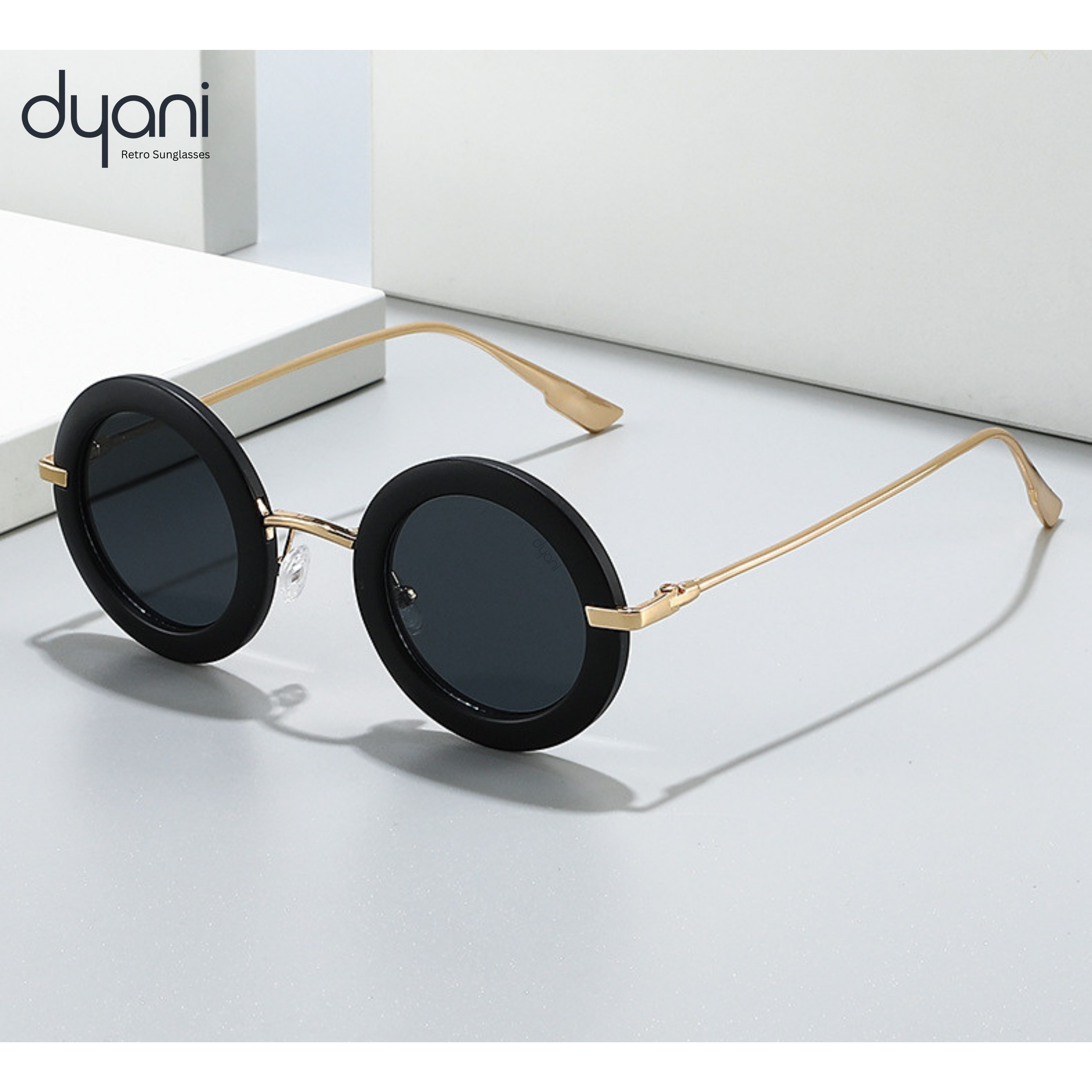 Stylish Solaris round-frame sunglasses with dark lenses and contrast rim, featuring sleek metal arms for a bold, retro-modern look.
