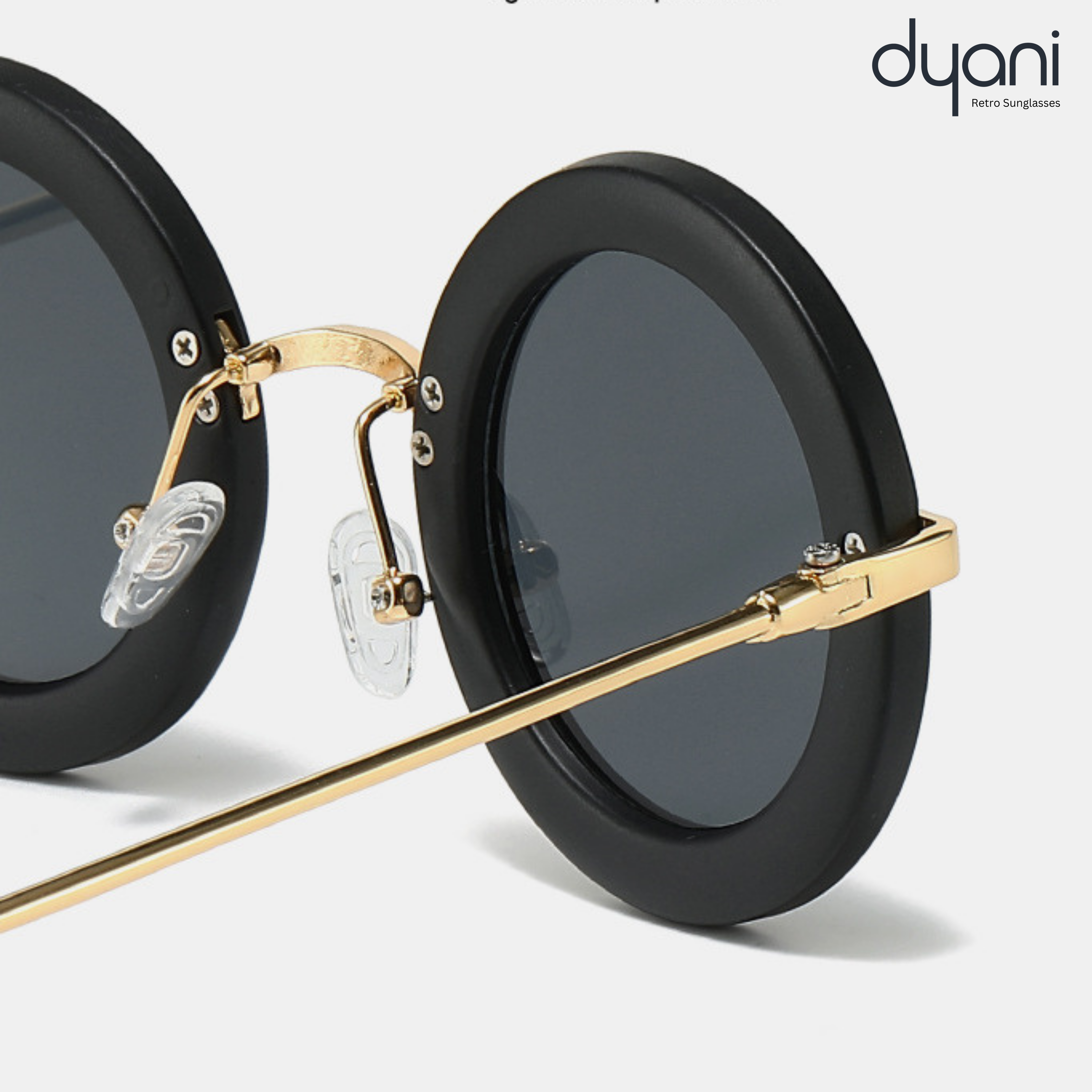 Solaris round-frame sunglasses by Dyani with bold contrast rims and sleek metal arms, featuring stylish retro design.