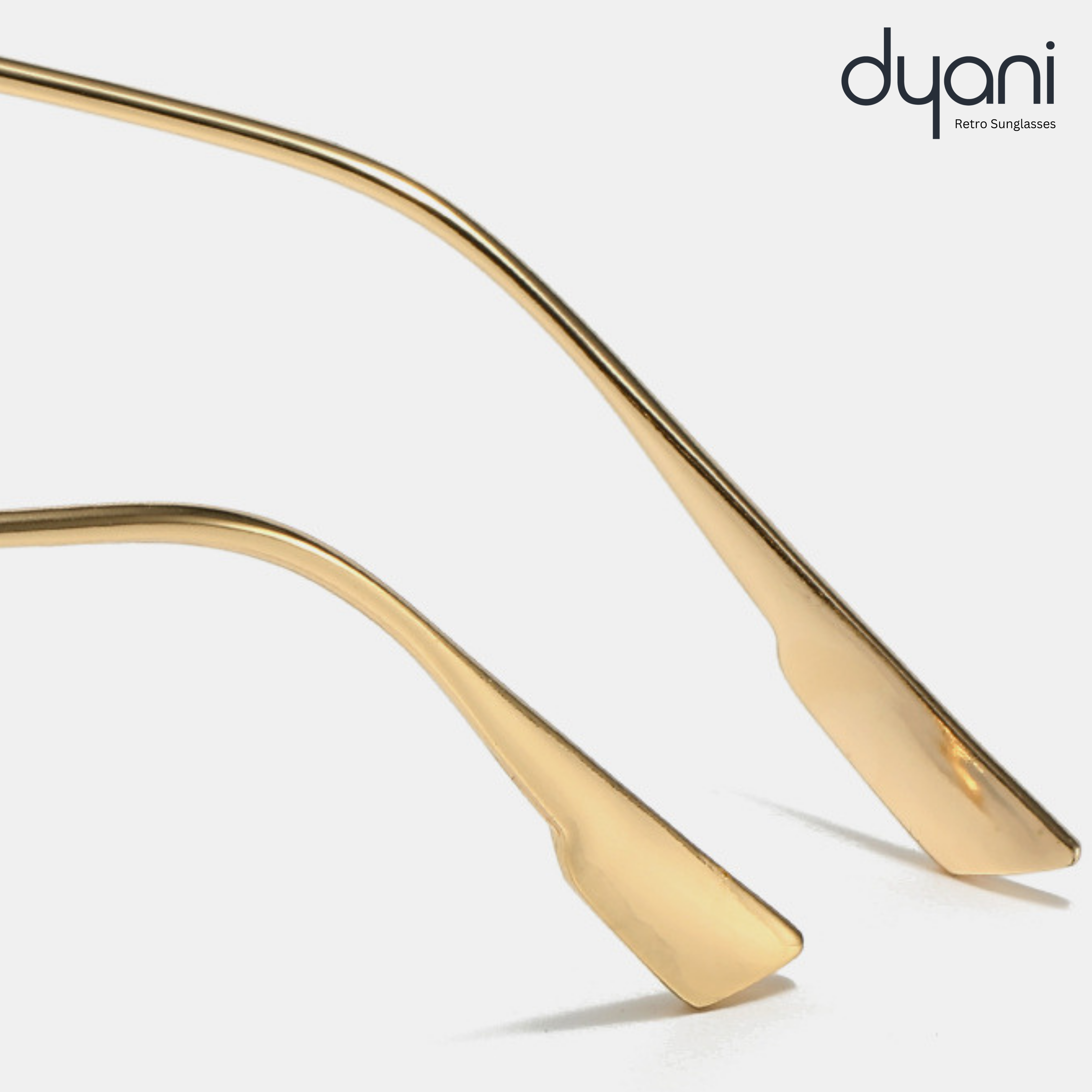 Close-up of Solaris sunglasses' sleek metal arms by Dyani, showcasing luxurious retro modern design with a gold finish.