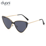 Cat-eye sunglasses with gold frame and dark lenses on a white background, branded 'dyani'.