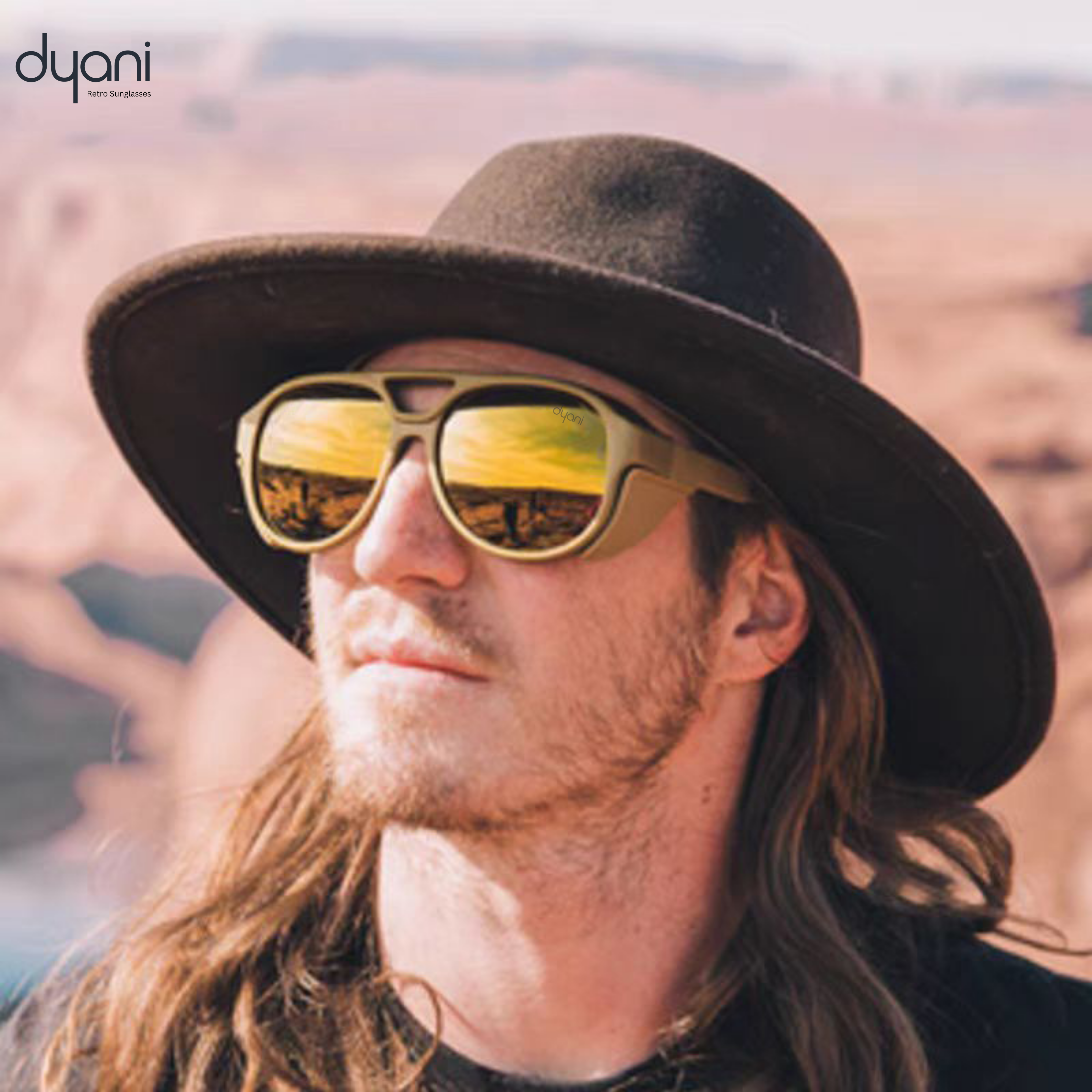 Man wearing Dyani Sunglasses in a retro round frame, with vibrant color flecks and angular detailing, against a desert backdrop.