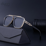Stylish Dyani sunglasses with bold square frames, featuring blue gradient lenses, resting on a sleek black case for modern flair.