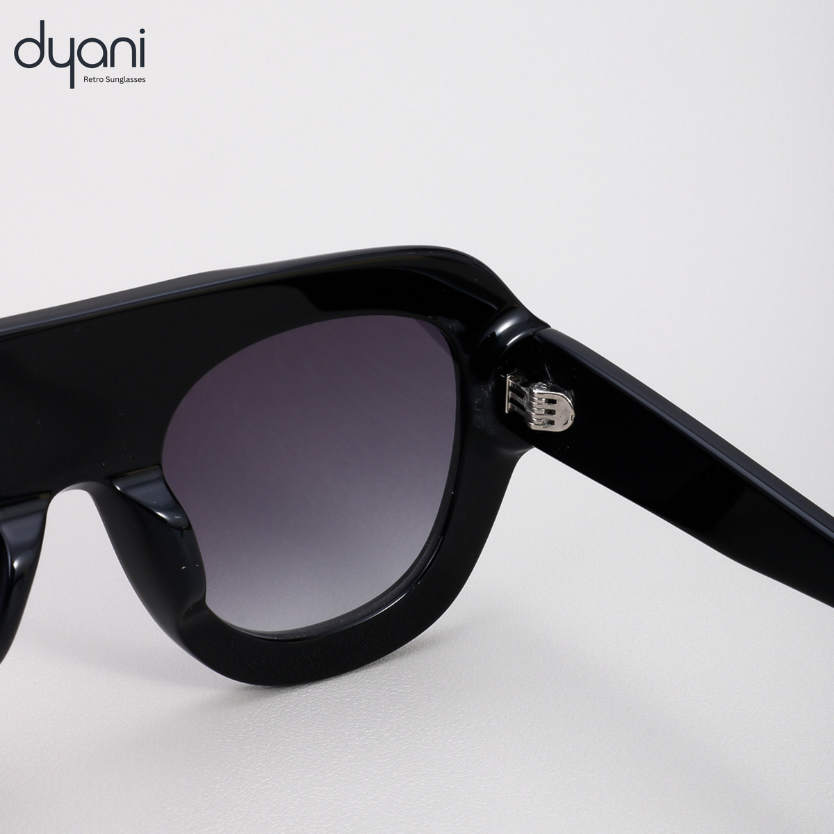 Velora sunglasses by Dyani with bold acetate frame and gradient UV400 lenses, blending retro and modern styles in sleek black.