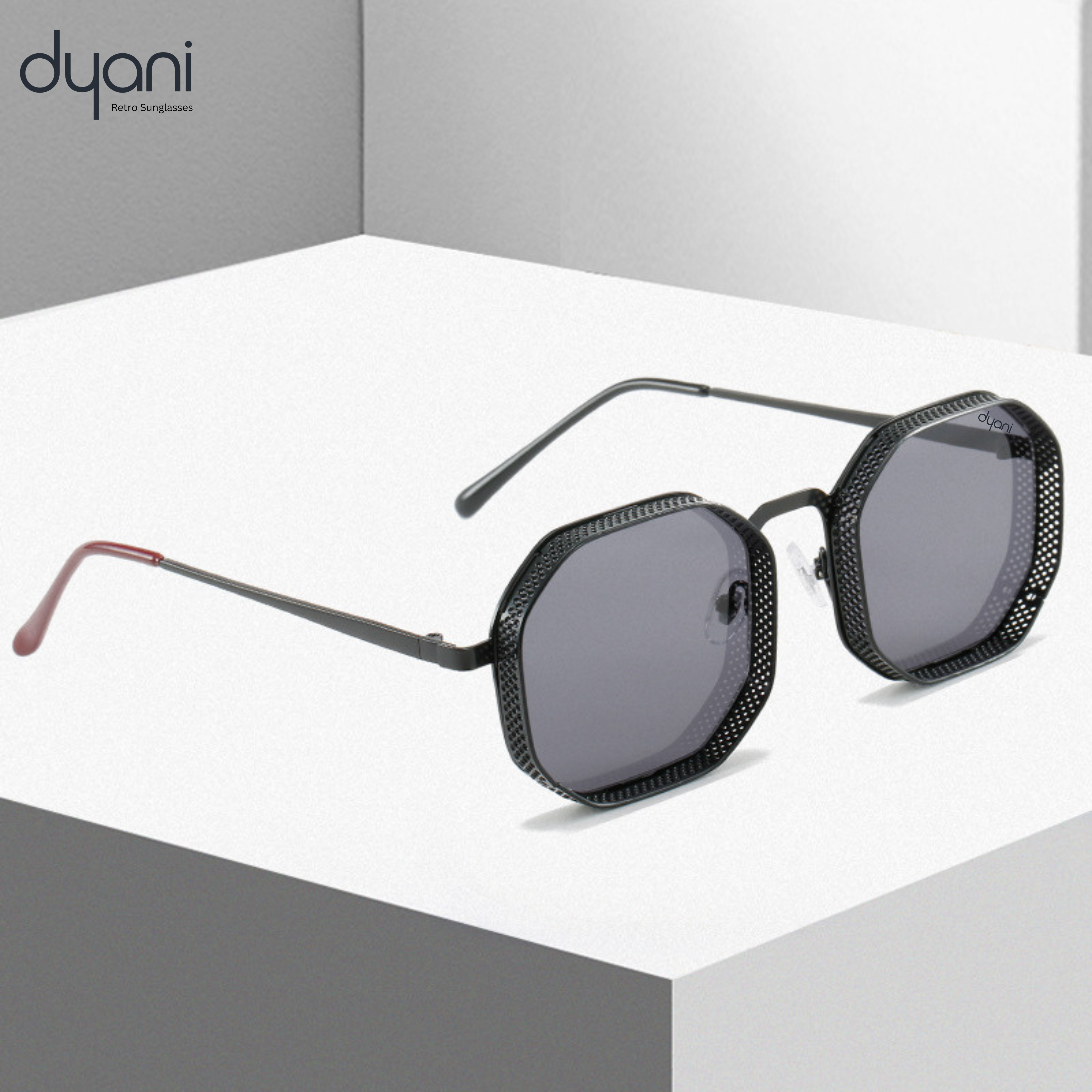 Stylish Dyani 'The Hex' sunglasses with metal frame and vintage steampunk design on white surface display.