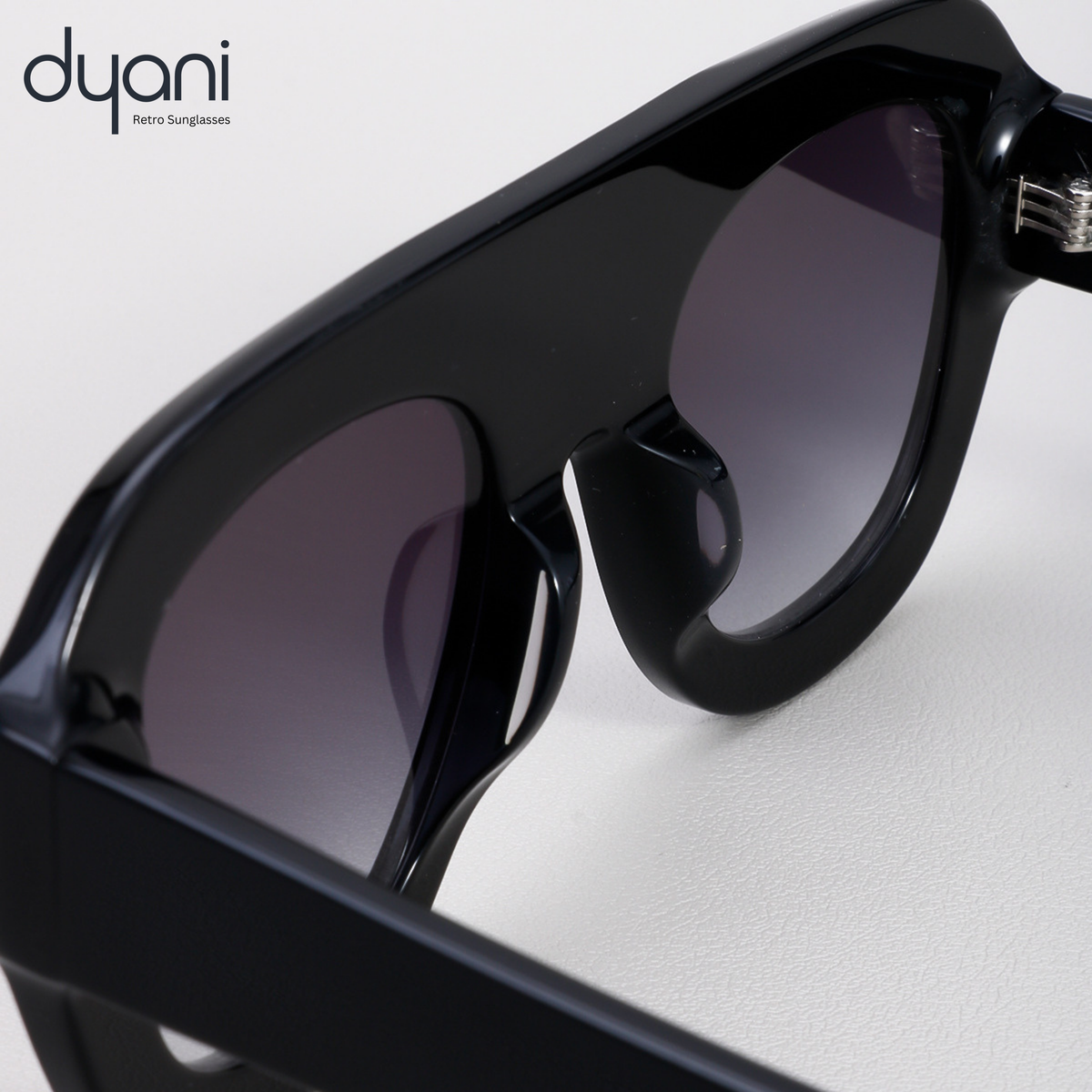 Dyani Velora sunglasses with bold, rounded acetate frame and gradient UV400 lenses, showcasing retro style and modern edge.
