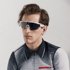 Man wearing The VantaX sunglasses with wraparound shield frame, sleek black design, and sporty style.