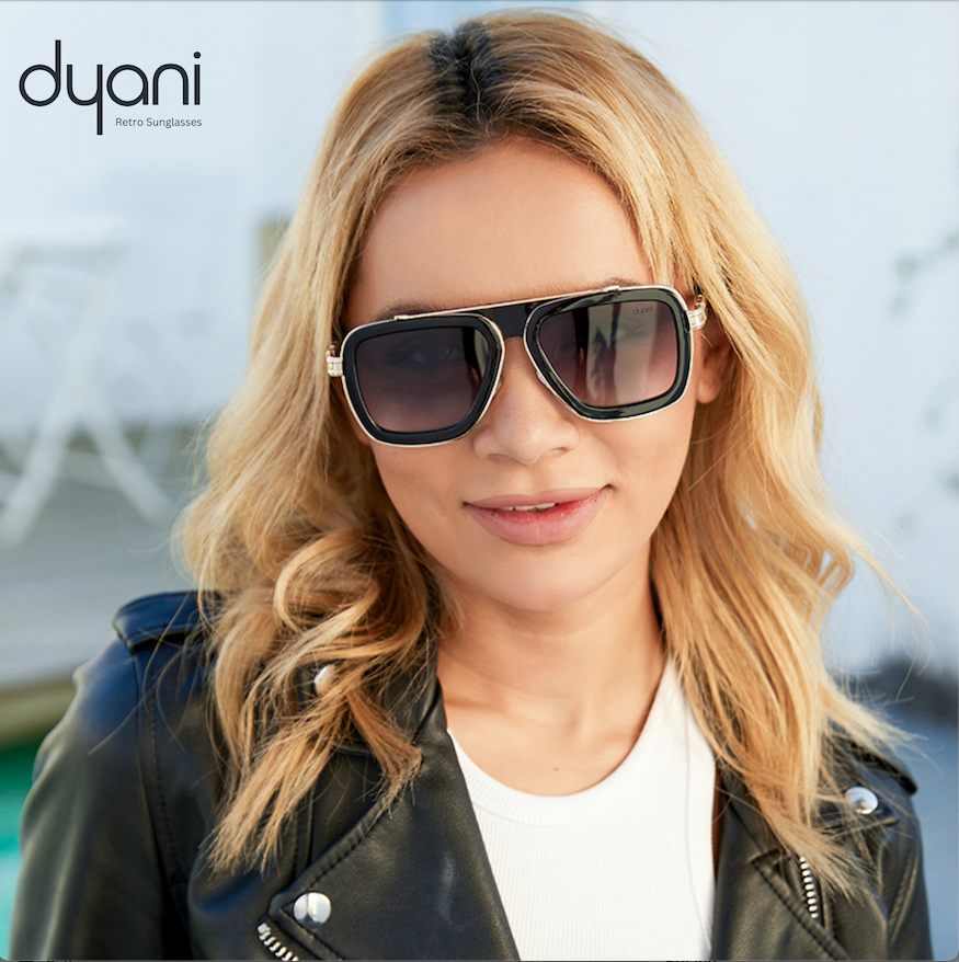 Woman wearing Dyani Stratos sunglasses with square silhouette and gradient lenses, smiling outdoors.