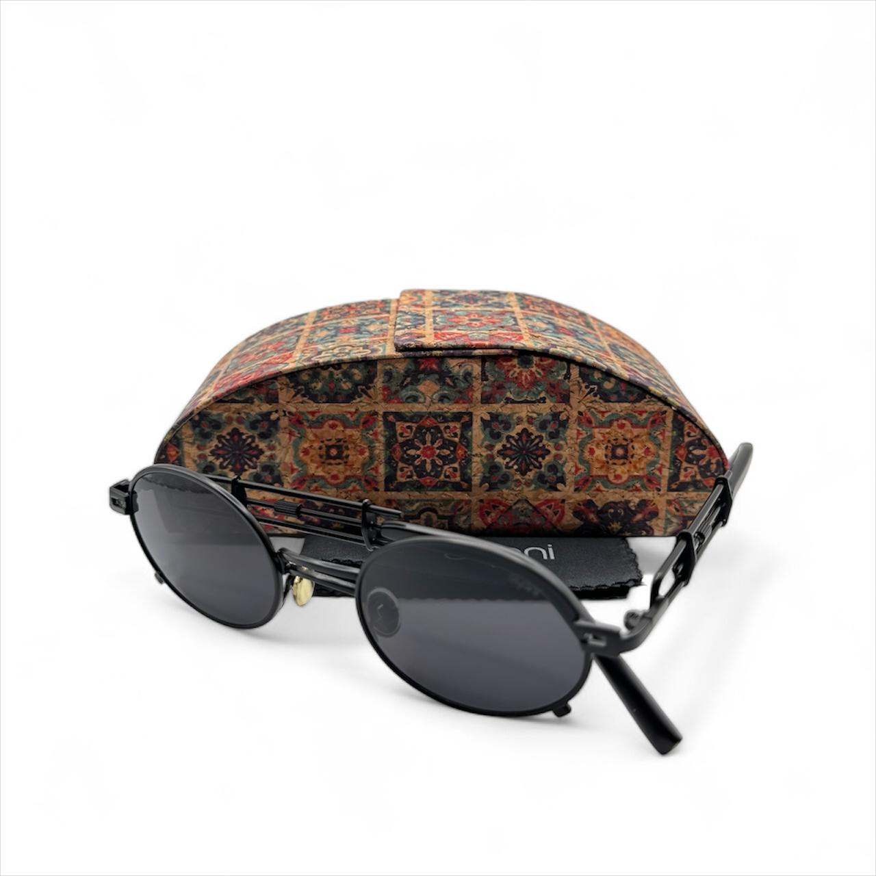 JazzyOval Metal Frame Retro Shades with oval lenses and crafted handles, alongside a patterned case, embodying modern flair and funk.